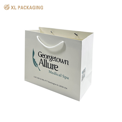 Logo de l'entreprise personnalisé Sacs de magasinage en papier de haute qualité Sacs à main en papier revêtus pour vêtements Chaussures et emballages de détail - Poignées robustes Discounts sur les commandes en vrac